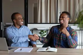 Overjoyed Africa American Business Partners Shaking Hands At Meeting